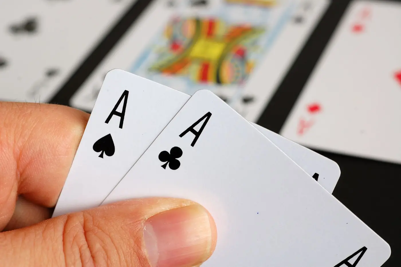 Hand holding a pair of aces