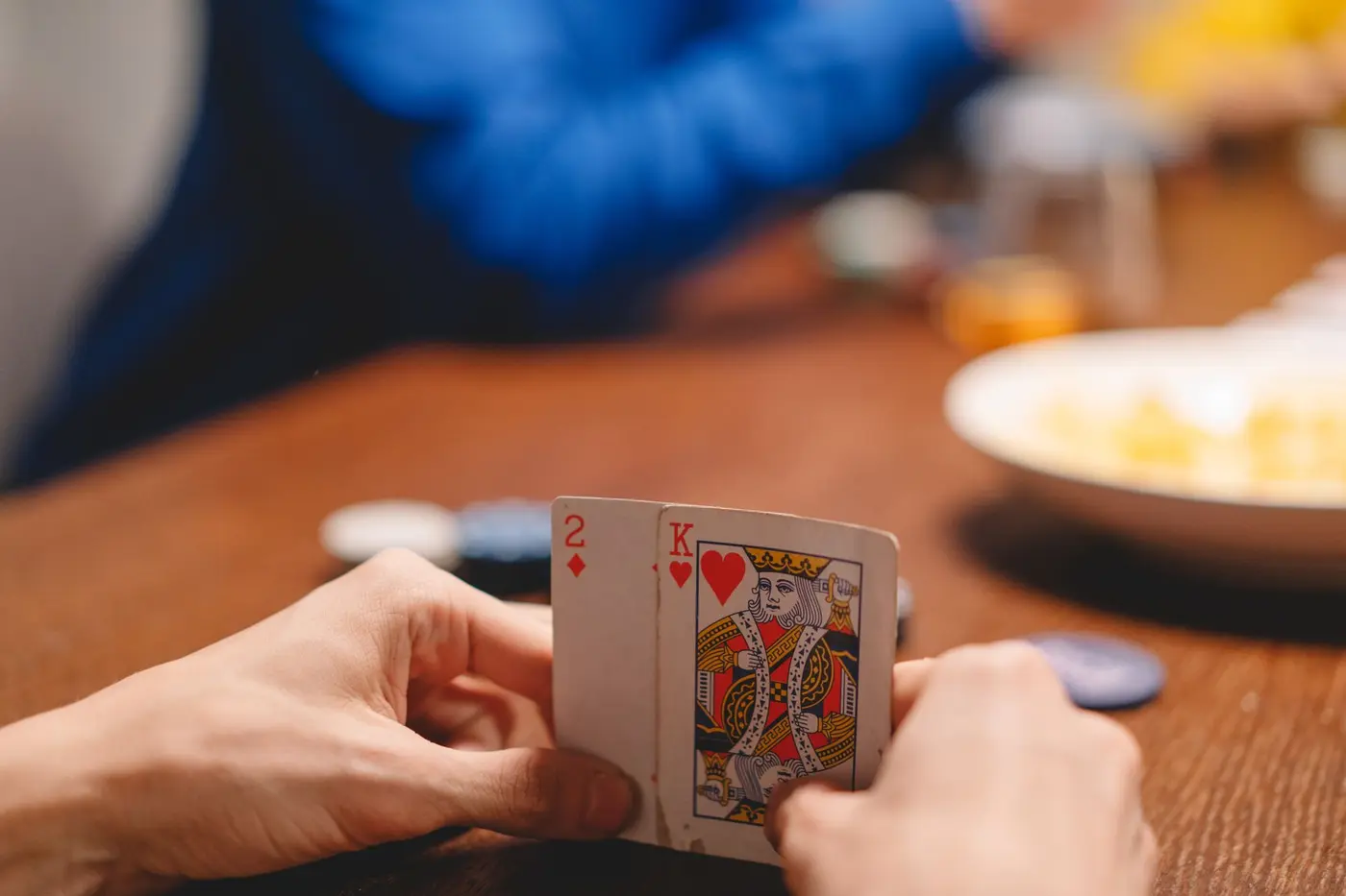 Person holding a hand of playing cards